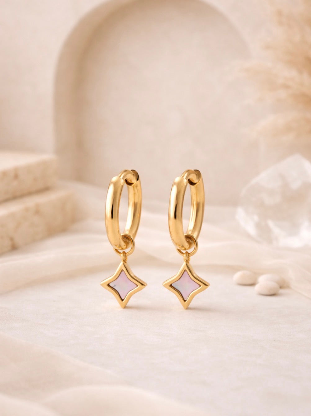 Elegant gold-toned hoop earrings featuring delicate star-shaped shell charms, part of the curated Earrings collection for a stylish and timeless look.