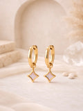 Elegant gold-toned hoop earrings featuring delicate star-shaped shell charms, part of the curated Earrings collection for a stylish and timeless look.