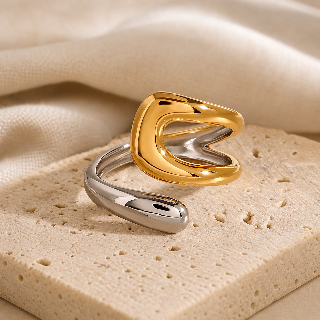 Open ring combining polished silver and gold tones with a modern, abstract design, featured in the Rings and Silver Collection, highlighting waterproof and tarnish-resistant qualities.
